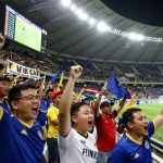 7m football fans celebrating with vibrant banners and scores in stadium atmosphere.