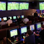 Engaging sports betting scene where bettors analyze odds and place nhận định bóng đá wagers amidst live match action