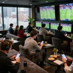 MM88 sports betting enthusiasts placing bets in a lively lounge